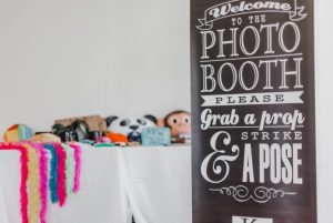 Photo booth sign with props table